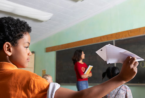 getty_rf_photo_of_boy_throwing_airplane_in_class